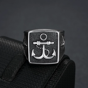 Detail view of vintage stainless steel anchor ring featuring embossed nautical design