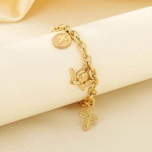 Detail view of gold angels and cross charms on a vintage stainless steel chain bracelet