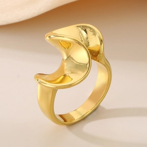 Macro shot of 18K gold plated stainless steel ring with abstract wavy curved texture