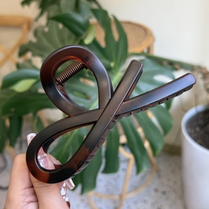 Large amber tortoise shell hair claw clip with twisted geometric design for thick hair