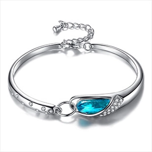 Détail d'un bracelet en argent avec une pierre bleue en poire et zircons scintillants