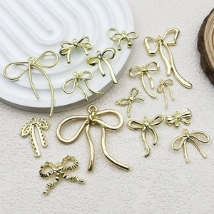 Golden bow-knot pendants in various styles for DIY jewelry making on white base