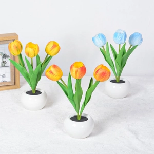 Three-head LED tulip night light in ceramic pot on a bright desktop setting