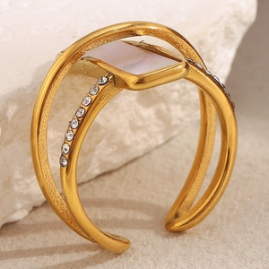 Detailed macro of 18K gold plated double-layer ring with shell and zircon inlay