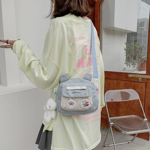 Cute light blue canvas crossbody bag with plush bear charm and cartoon patches