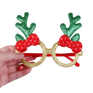 Close-up of Christmas party glasses featuring green sequin antlers and red polka dot bow