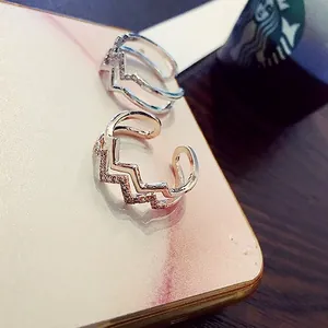 Dual layer wave open rings in silver and rose gold finishes with sparkling crystals