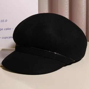 Detail of black wool octagonal hat with sparkling bead decoration and elegant texture