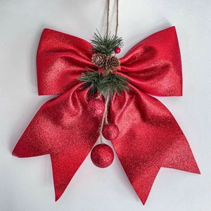 Red glitter Christmas bow with pine cones and hanging ornaments for tree decoration