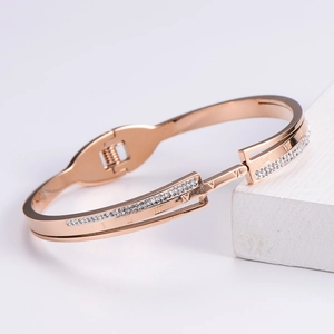Rose gold Roman numeral elastic bracelet with crystal inlay on white pedestal