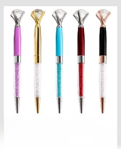 Close-up of creative metal diamond pens with sparkling crystal fillers in five colors