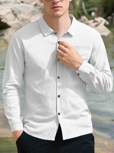 Close-up of white linen shirt showing textured seersucker fabric and button detail