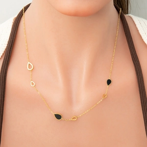 18k gold plated stainless steel necklace with black and gold teardrop pendants on a model