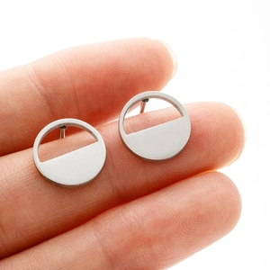 Close-up showing the actual size and minimalist geometric circular design of the stud earrings