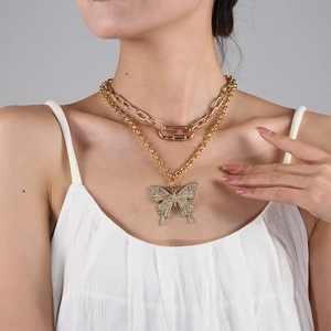 Double-layered gold necklace with rhinestone butterfly pendant and chunky chain links