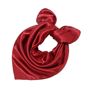 Close-up of vibrant red satin silk square scarf showing smooth texture and glossy shine