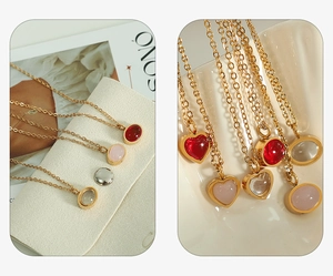 Detailed close-up of golden necklaces with heart and oval red agate pendants