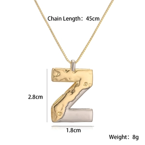 Macro view of two-tone gold and silver letter Z pendant with size and weight metrics