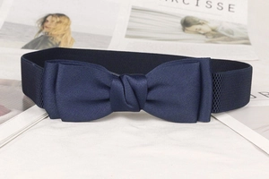 Detailed close-up of dark blue elastic cinch belt featuring a large decorative fabric bow