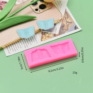 Pink silicone book mold for chocolate fondant with finished blue resin graduation book pieces