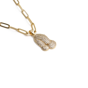 Detailed view of gold plated paperclip chain with zircon encrusted pendant