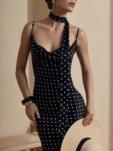 Detail of polka dot maxi dress with matching neck scarf and straw hat accessory