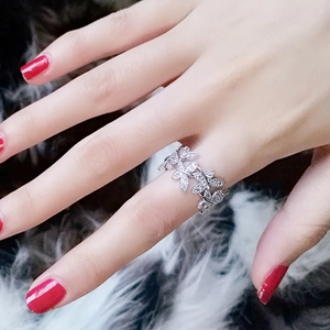Exquisite leaf-shaped wrap ring with shimmering crystal inlay on polished silver metal