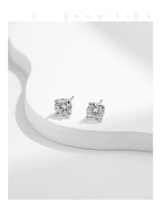 Detailed view of four-prong round solitaire moissanite stud earrings in S925 sterling silver