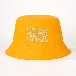 Bright yellow canvas bucket hat with white I LOVE MY BODY embroidery in a minimalist style
