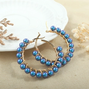 Handmade stainless steel hoop earrings with blue and purple iridescent shell beads