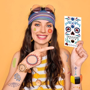 Macro view of Halloween temporary sugar skull tattoo stickers on skin with floral patterns