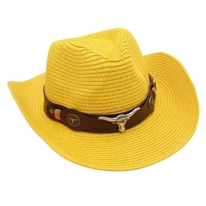 Close-up of yellow western straw cowboy hat with longhorn bull head metal accessory