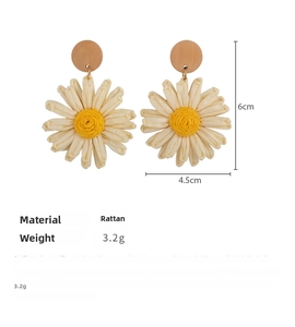 Close-up of handmade straw woven daisy earrings with wooden studs and size measurements