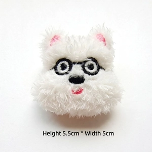 Detail view of a white plush puppy patch with glasses, size 5.5cm height and 5cm width