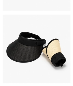 Detail of foldable straw sun visor showing black and beige colors with roll-up storage design