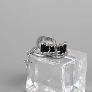 Close-up of silver star ring with black zircon on ice block display with cool tones
