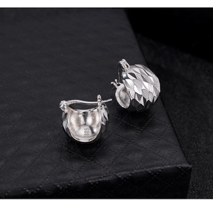 Detailed macro view of S925 sterling silver earring with CNC laser diamond-cut texture