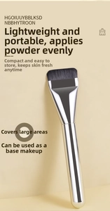 Flat top foundation brush with dense black bristles and silver metallic handle detail