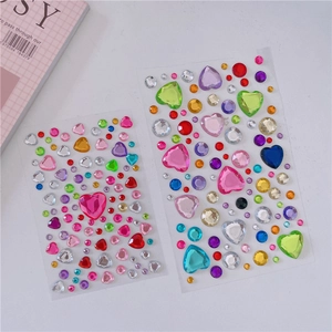 Close-up of colorful heart and round acrylic gemstone stickers for DIY craft decoration