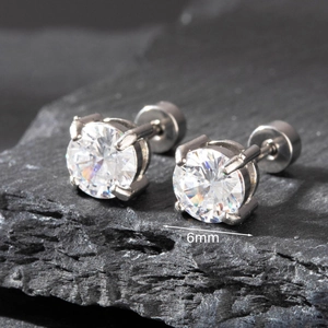 Macro view of 6mm cubic zirconia stud earrings with six-prong setting on grey stone