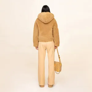 Back view of a camel plush hooded jacket paired with matching straight casual trousers