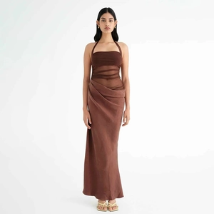 Detail of brown halter maxi dress featuring sheer mesh waist and pleated slit skirt