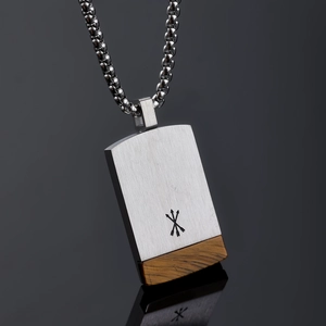 Macro view of silver stainless steel rectangle pendant with brown stone inlay and arrow engraving