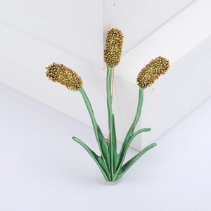 Elegant gold and green plant brooch with three enamel leaves on white background