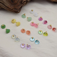 Detailed close-up of colorful floral bud resin earrings with elegant golden bead accents