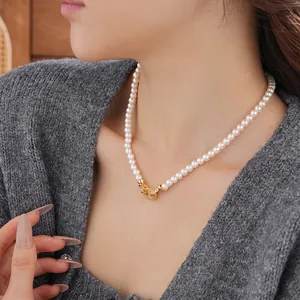 French vintage pearl necklace with golden zircon oval buckle on model neck