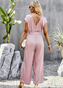 Detail of pink jumpsuit featuring a deep V-back design with a stylish tie-back knot