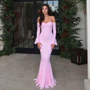 Close-up of pink lace evening gown featuring a strapless fishtail design with flared sleeves