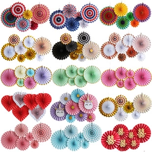Various decorative paper fans in round and heart shapes for festive party decorations