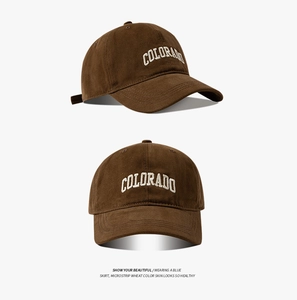 Detail view of brown cotton baseball cap with white Colorado embroidery on front and side